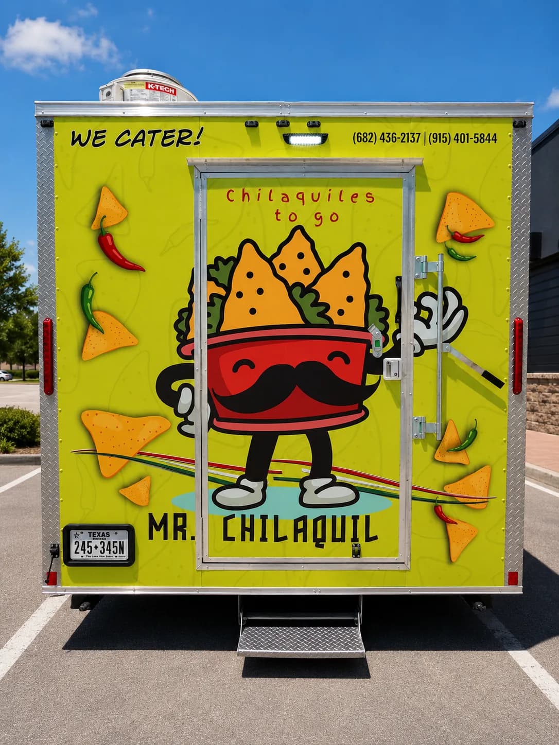 Rear view of the Mr. Chilaquil trailer showing the wrapped door and mascot