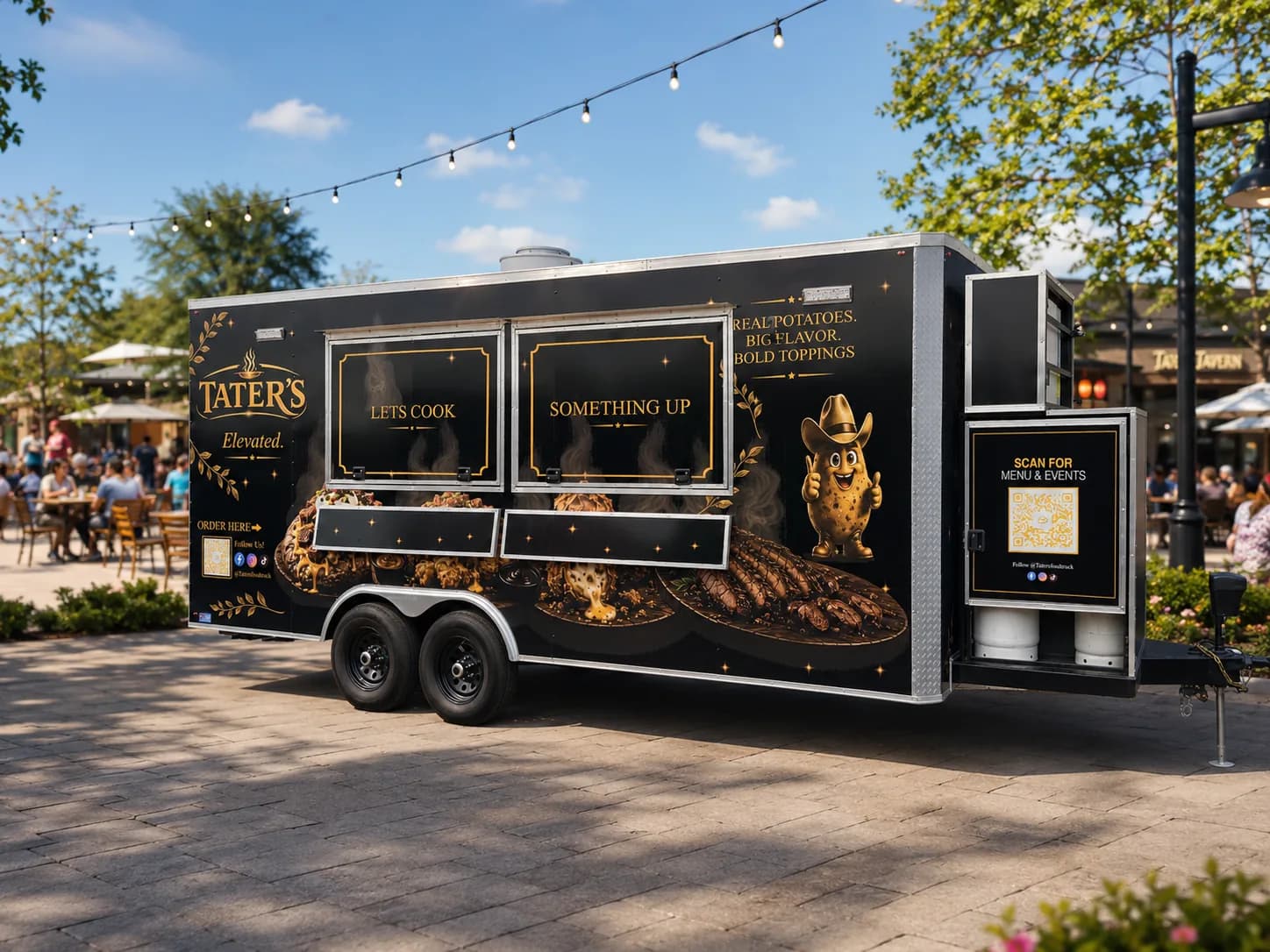 Black and gold wrapped food trailer for Tater's Elevated at a busy plaza